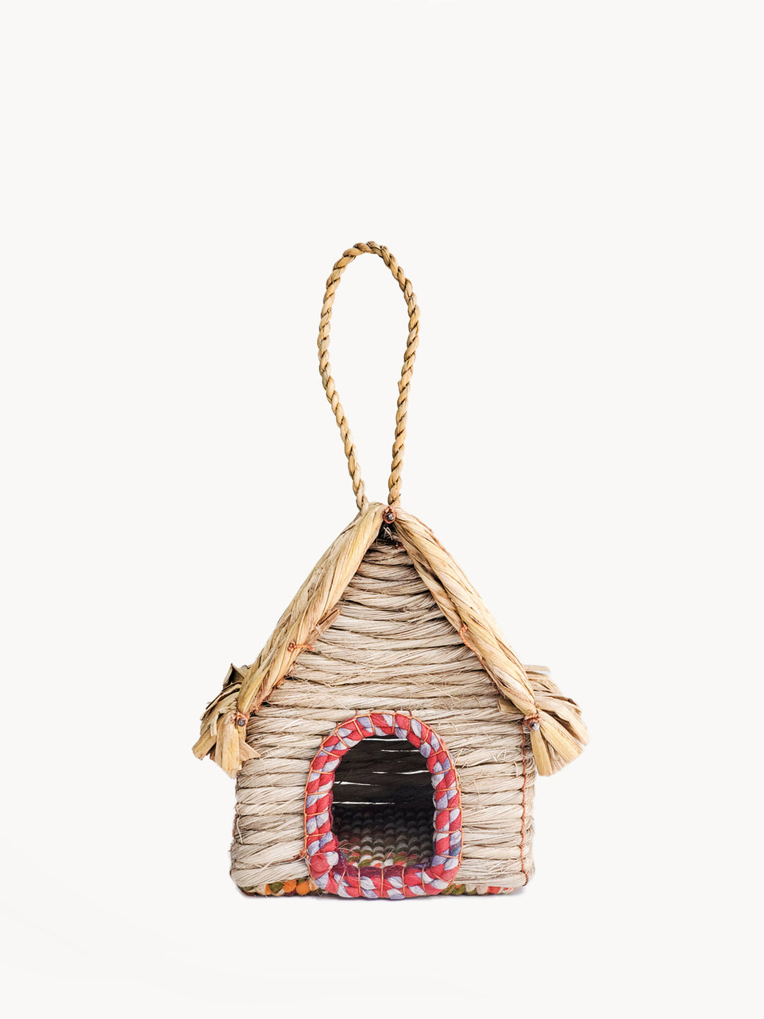 Cabin-style seagrass birdhouse with peaked thatched roof and sari-trimmed arched entry
