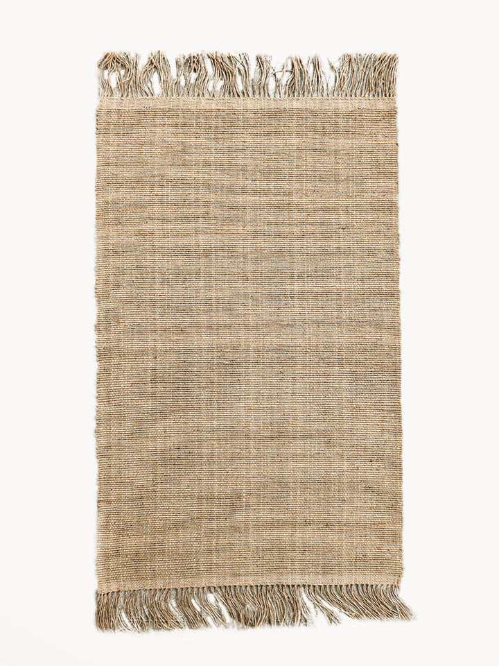 Hand-braided jute area rug in natural color with fringed ends