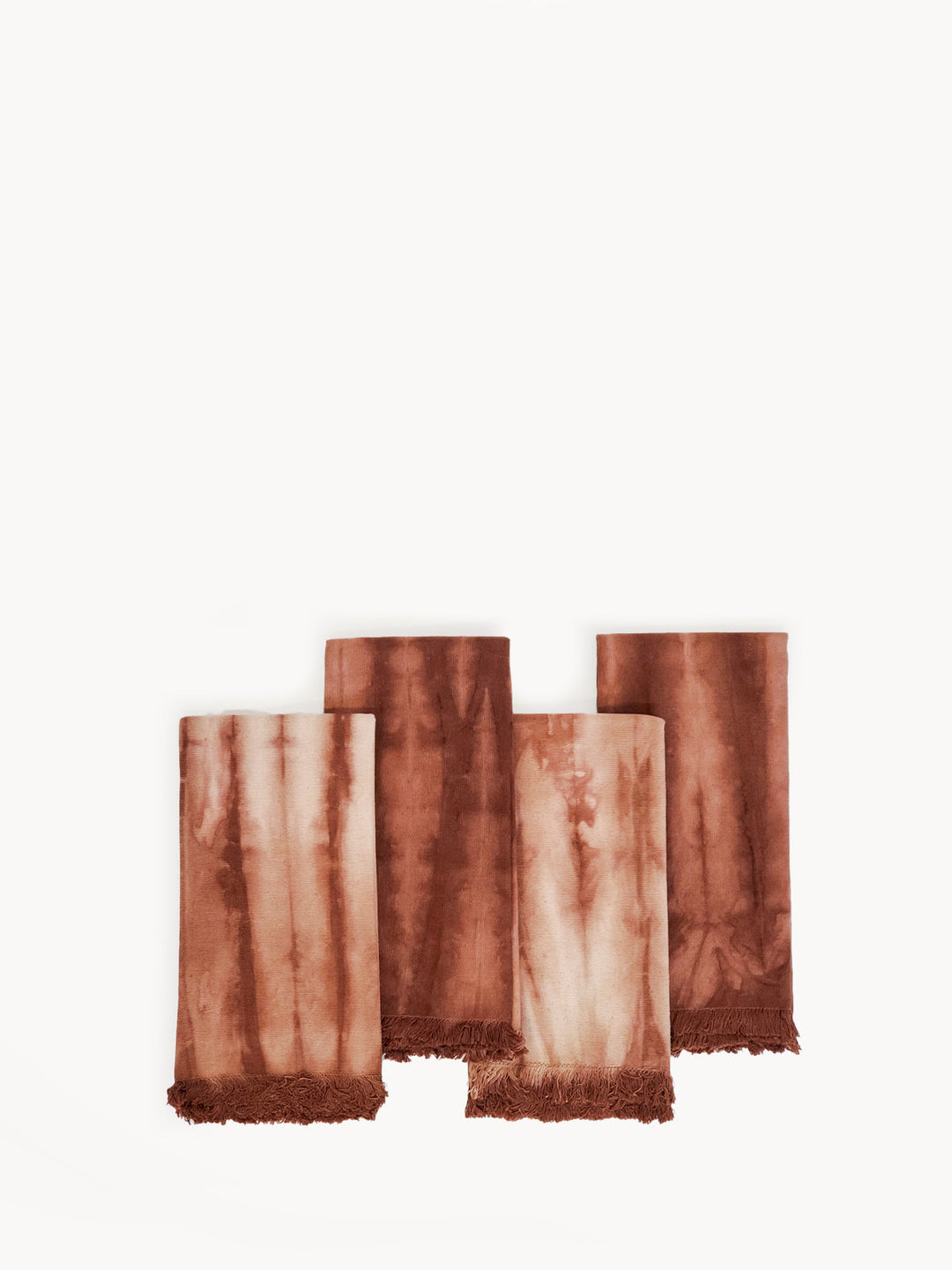 Fringed shibori-dyed cotton dinner napkins in warm rust and cream, set of 4