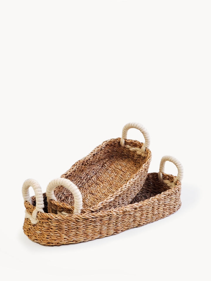 Set of two handwoven seagrass bread baskets with white handles
