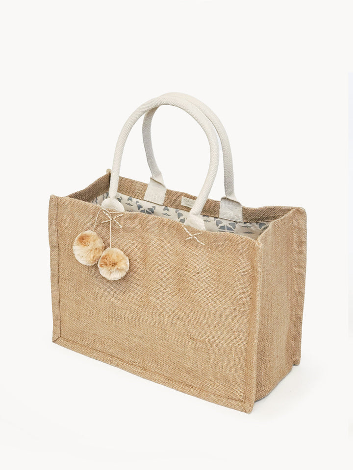 Jute canvas shopping bag with colorful pompom accents and roomy interior