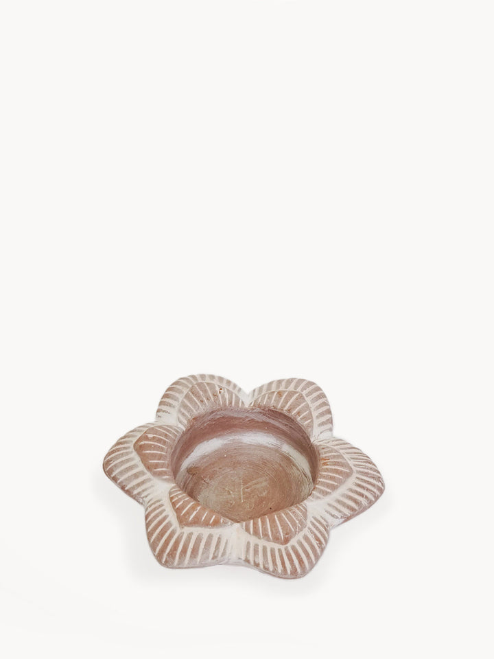Terracotta flower-shaped tea light holder with a hollow center for a candle