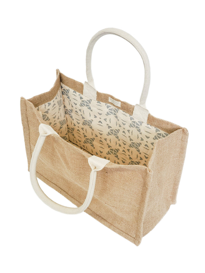 Eco-friendly jute canvas shopping bag with a playful pompom detail