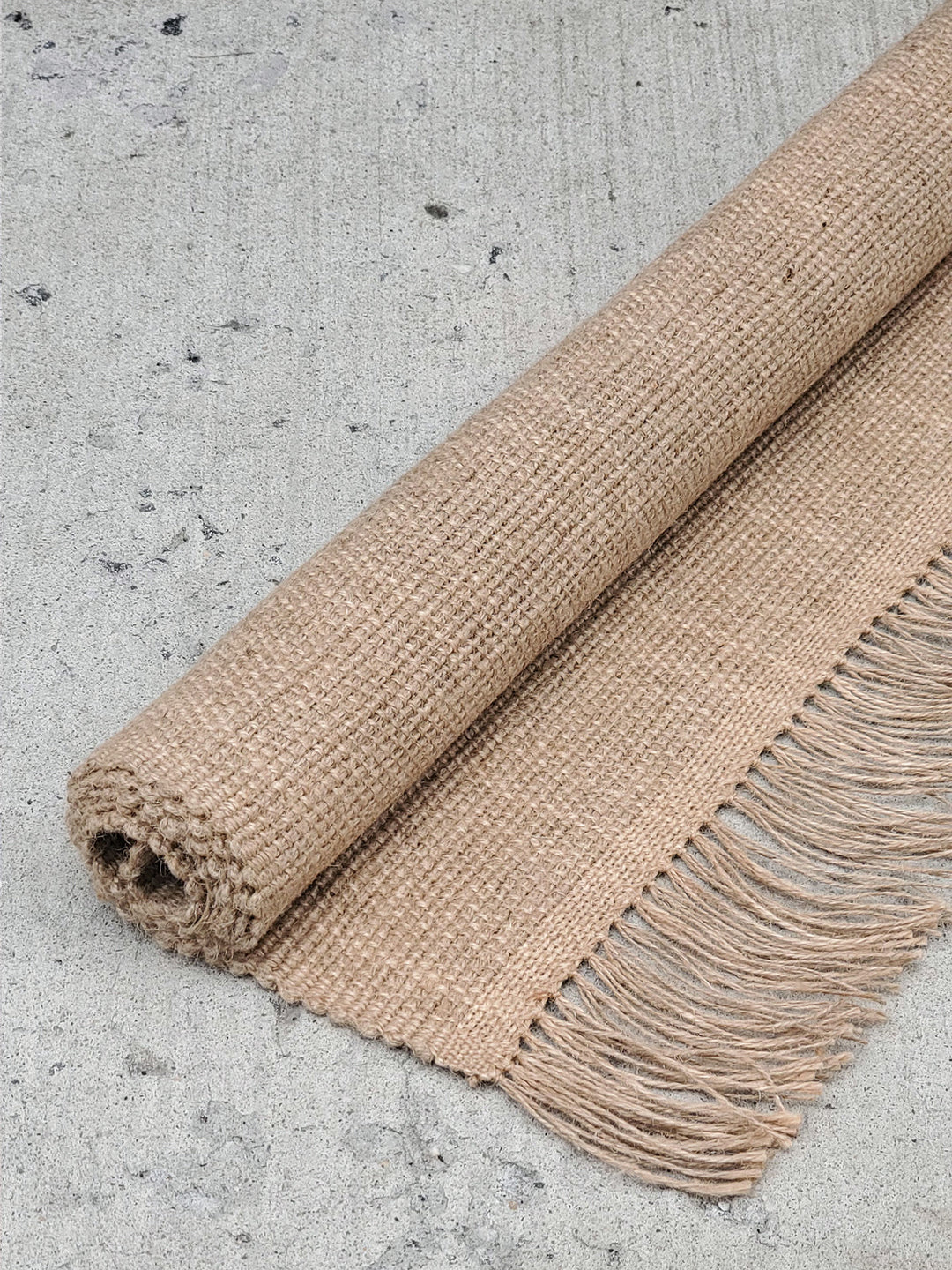 Natural jute area rug with beige and earthy tones, hand-braided