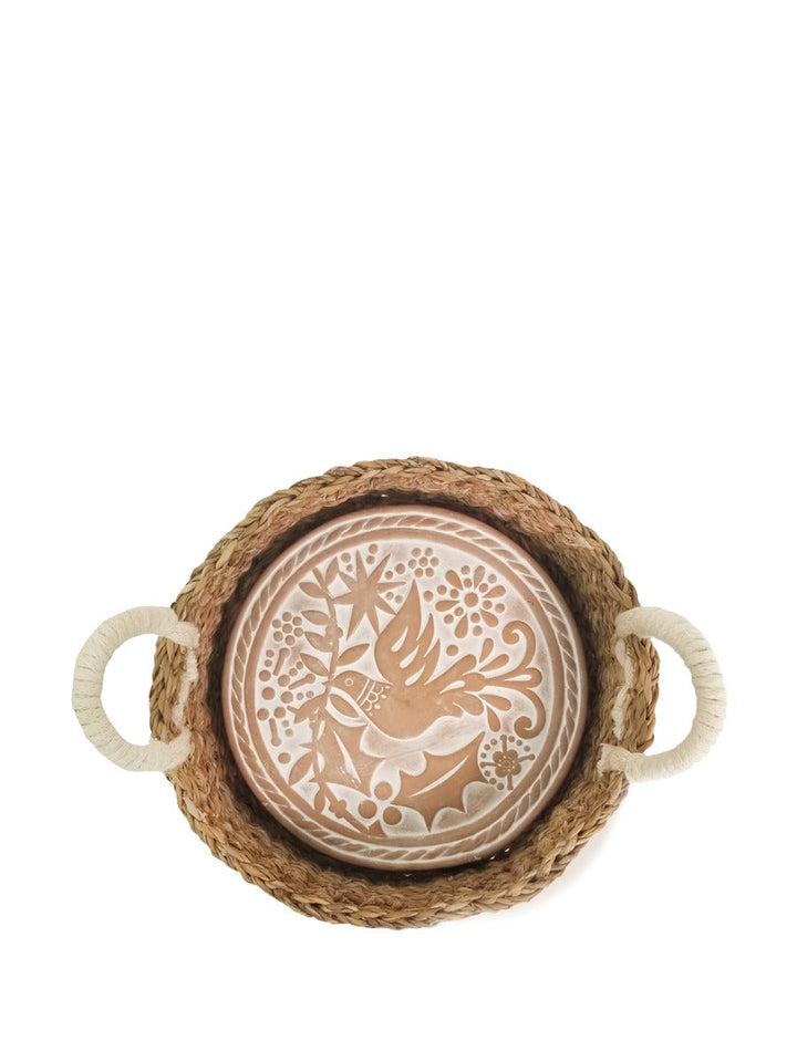 Terracotta bird plate resting inside its round seagrass bread basket