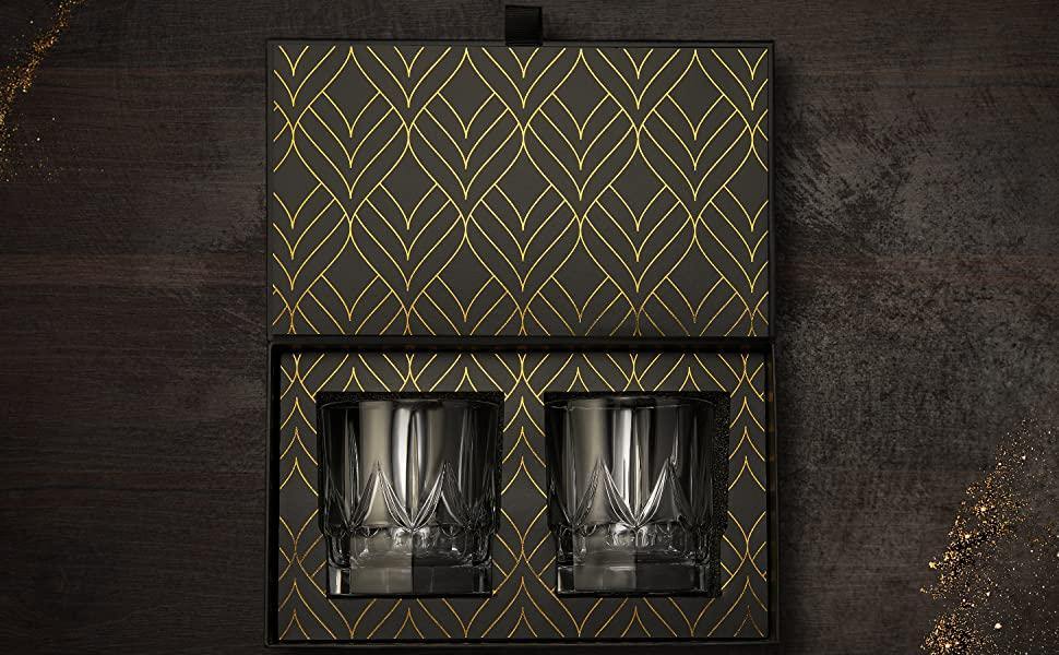 Crystal whiskey tumblers, handcrafted glassware shown on a wooden surface.