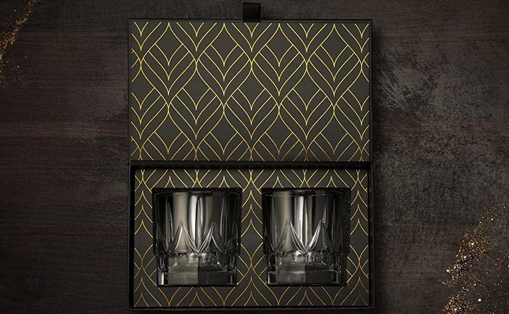 Crystal whiskey tumblers, handcrafted glassware shown on a wooden surface.