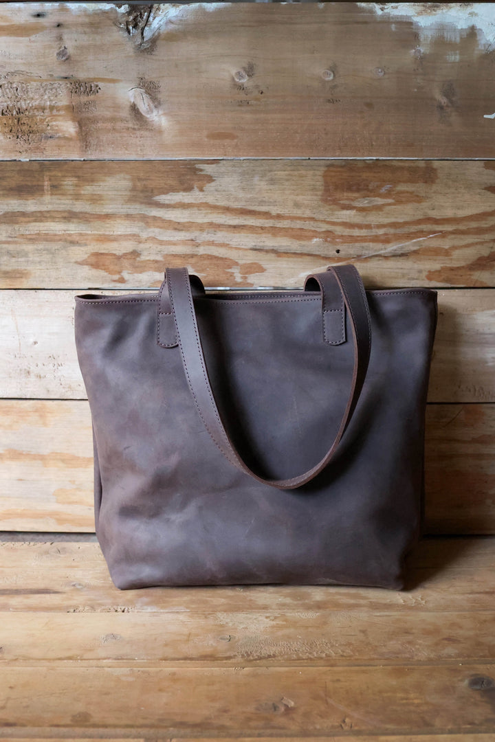 Large full-grain leather tote bag with a spacious interior and interior pocket.