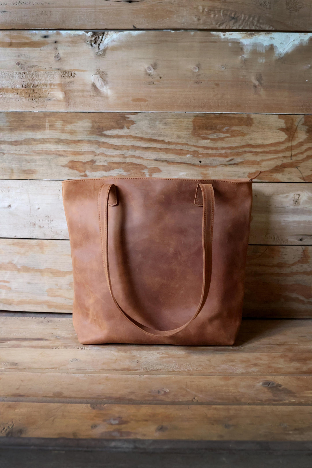 Large full-grain leather shoulder tote with sturdy handles, handmade in Kenya.
