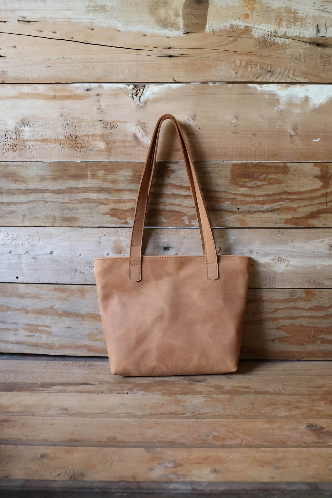 Handmade full-grain leather tote with sturdy handles for daily essentials.