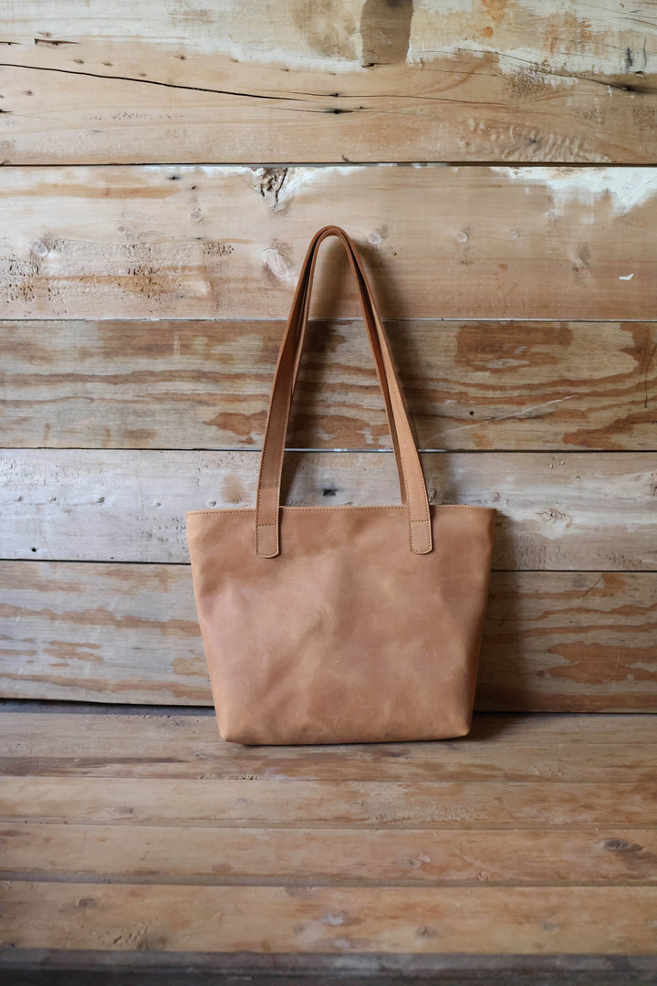 Handmade full-grain leather tote with sturdy handles for daily essentials.