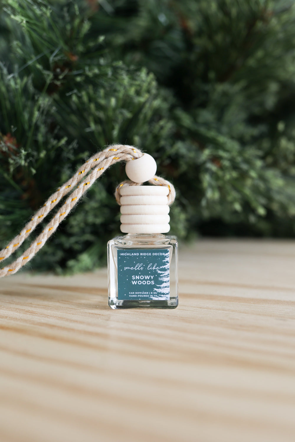 Snowy Woods car diffuser bottle with a snowy woodland scene.