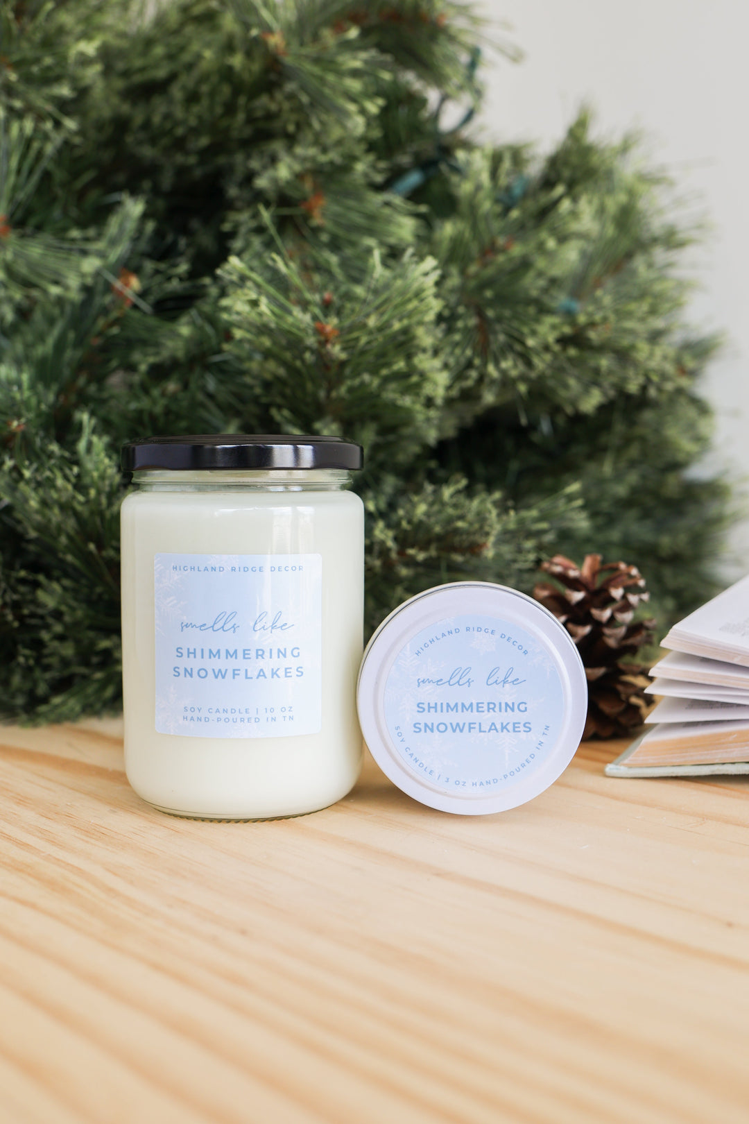 Hand-poured soy Shimmering Snowflakes candle with a winter snowflake design.