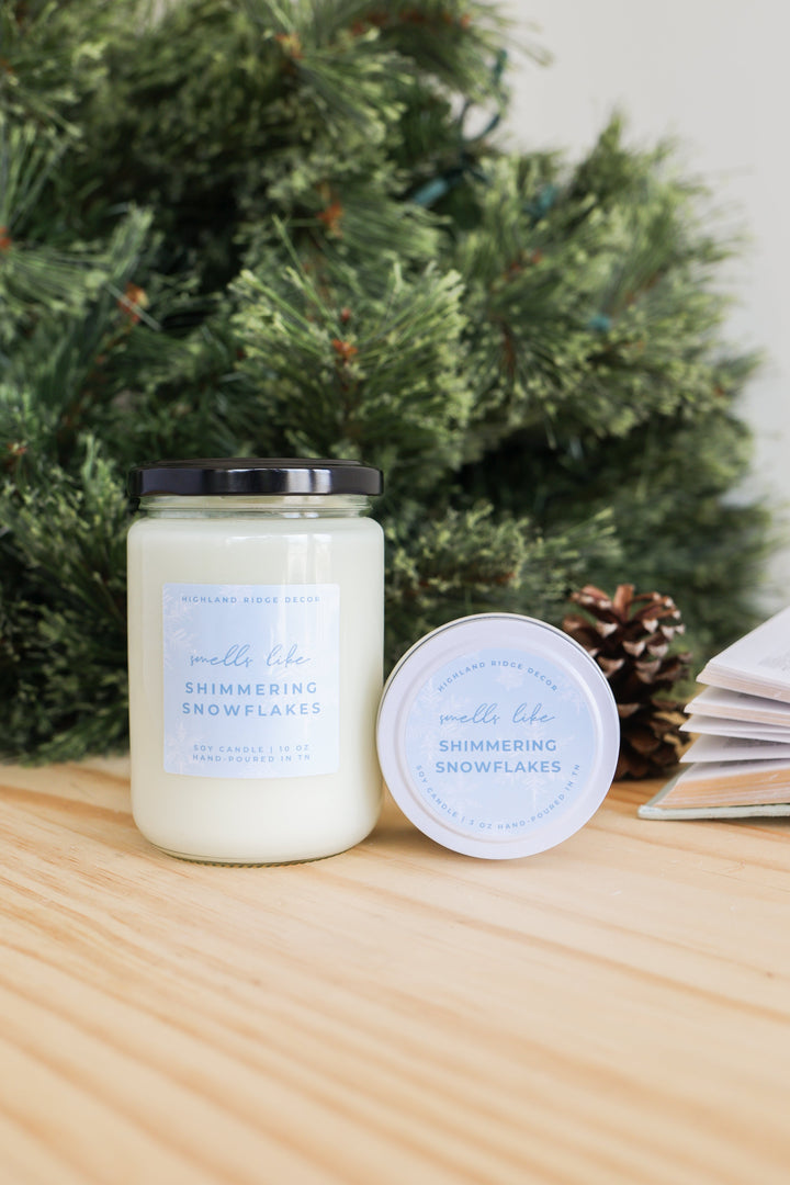 Hand-poured soy Shimmering Snowflakes candle with a winter snowflake design.