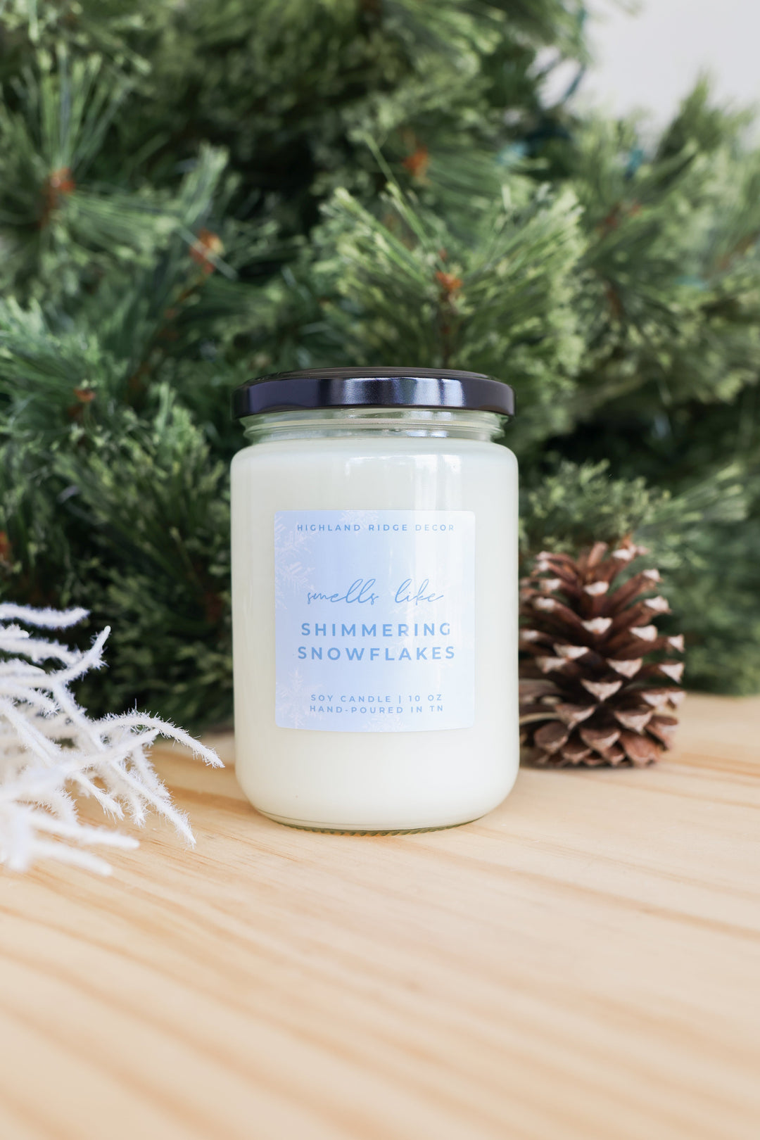 Shimmering Snowflakes soy candle with a winter snowflake label.