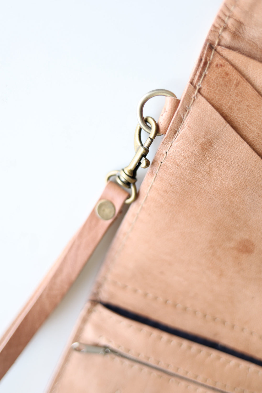 Handmade leather wristlet wallet, compact with card slots and a leather strap.