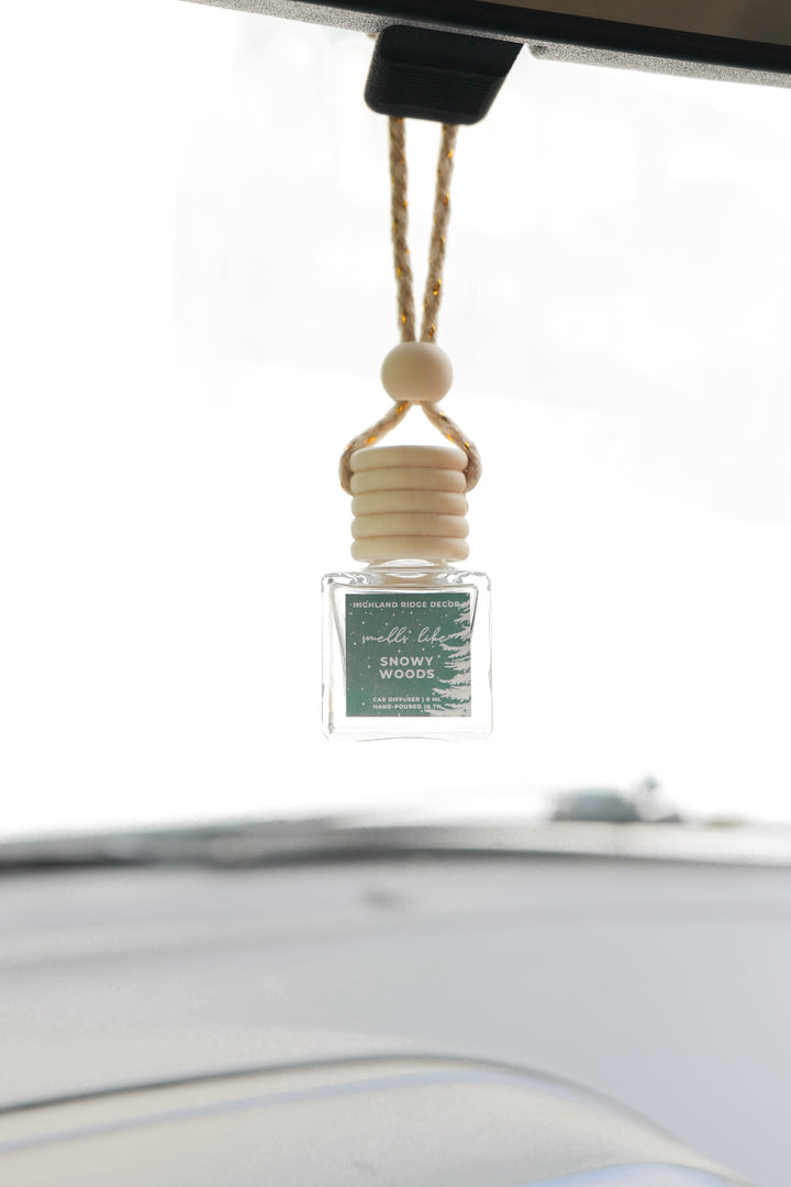 Snowy Woods car diffuser with a snowy woodland scene.