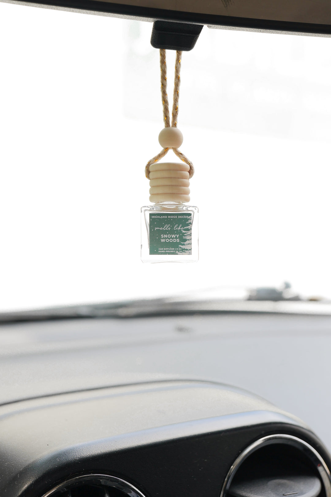 Snowy Woods car diffuser with a wood-grain cap and snow design.