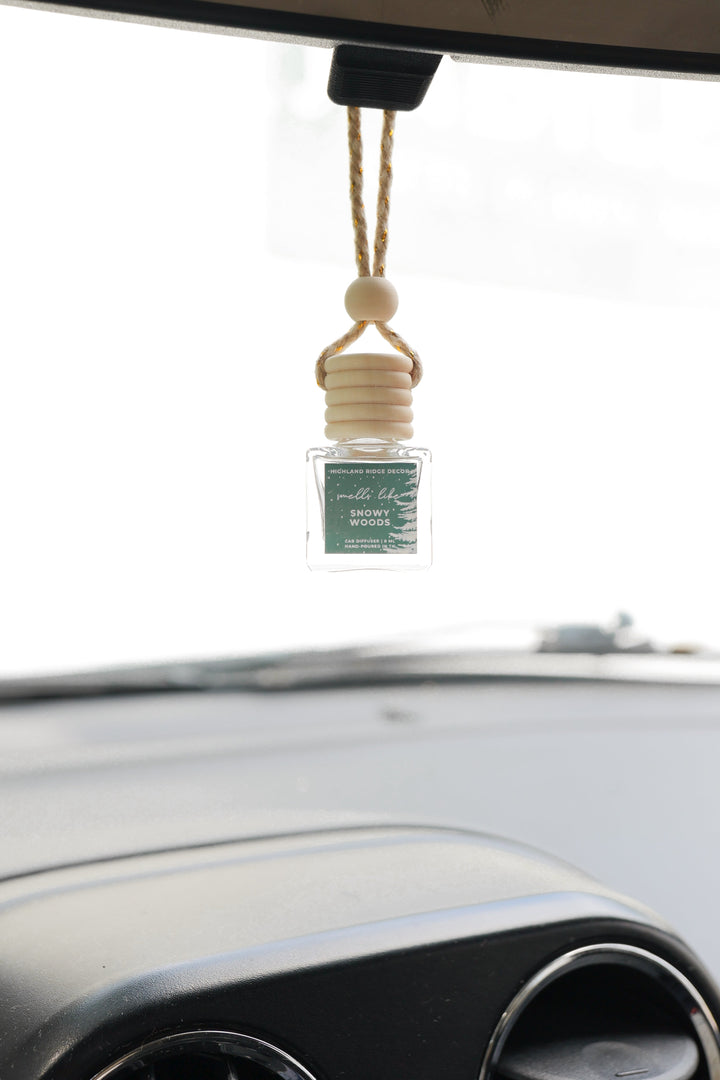 Snowy Woods car diffuser with a wood-grain cap and snow design.
