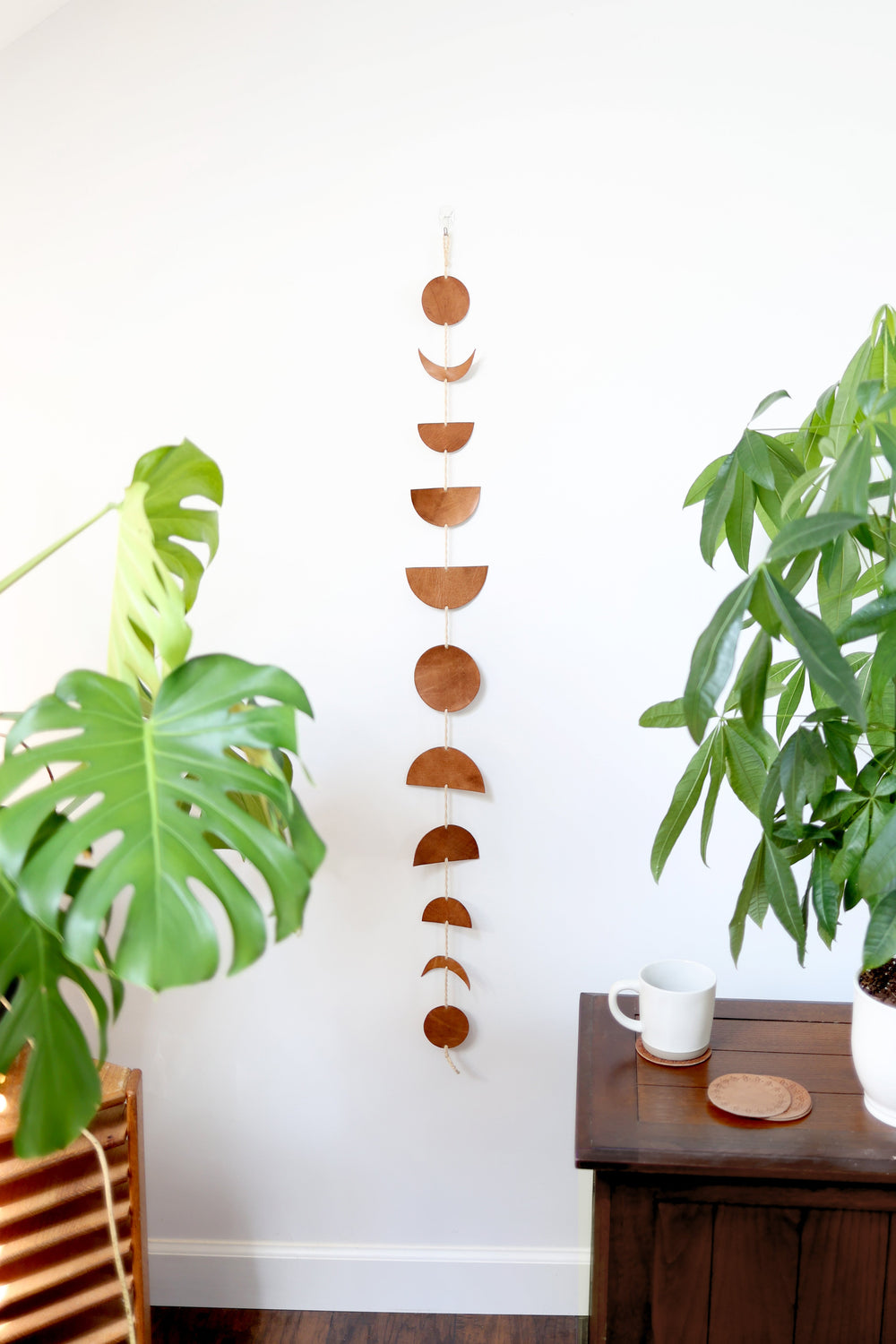 Leather Luna moon-phase garland with crescent and full moon shapes.