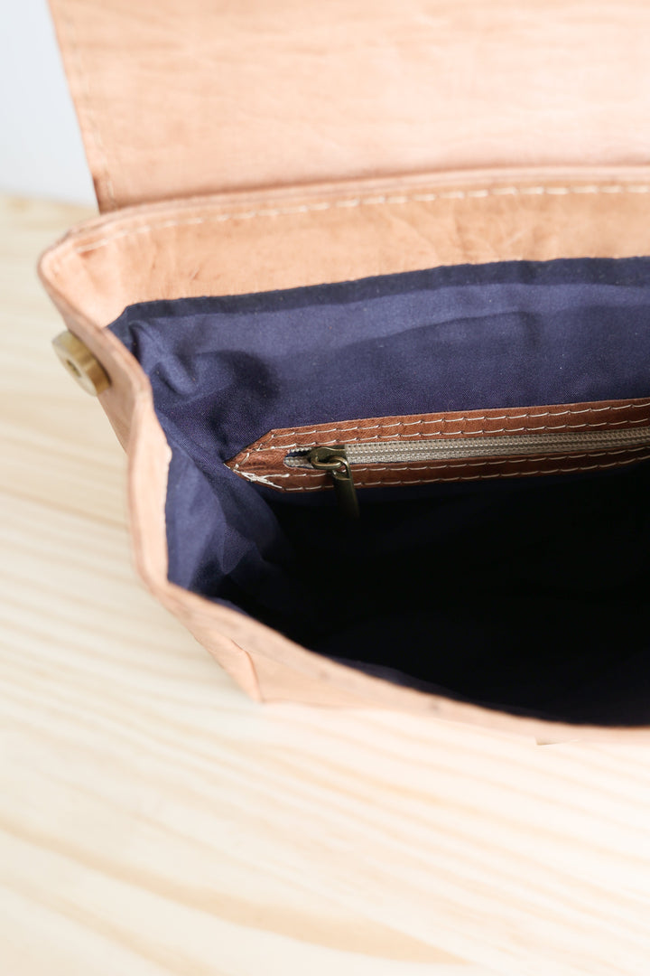 Small leather backpack with sturdy adjustable straps and a classic design.