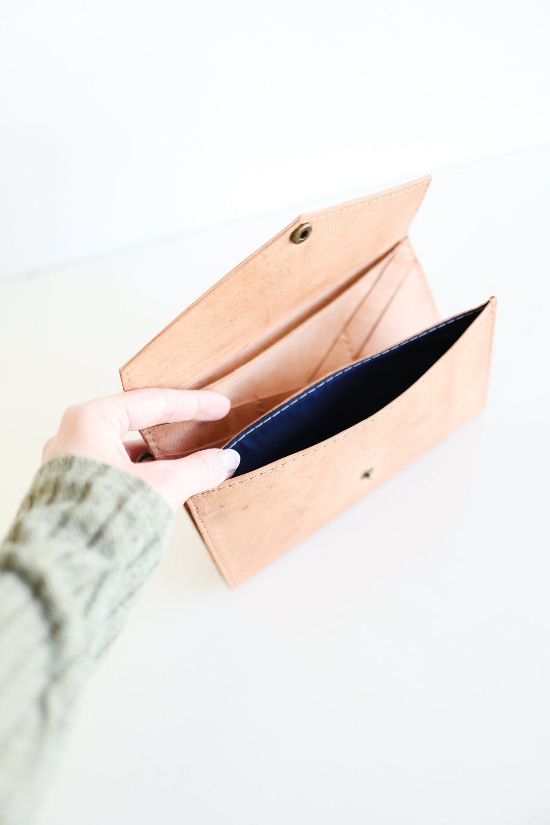 Handmade brown leather wristlet wallet with a wrist strap and card slots.
