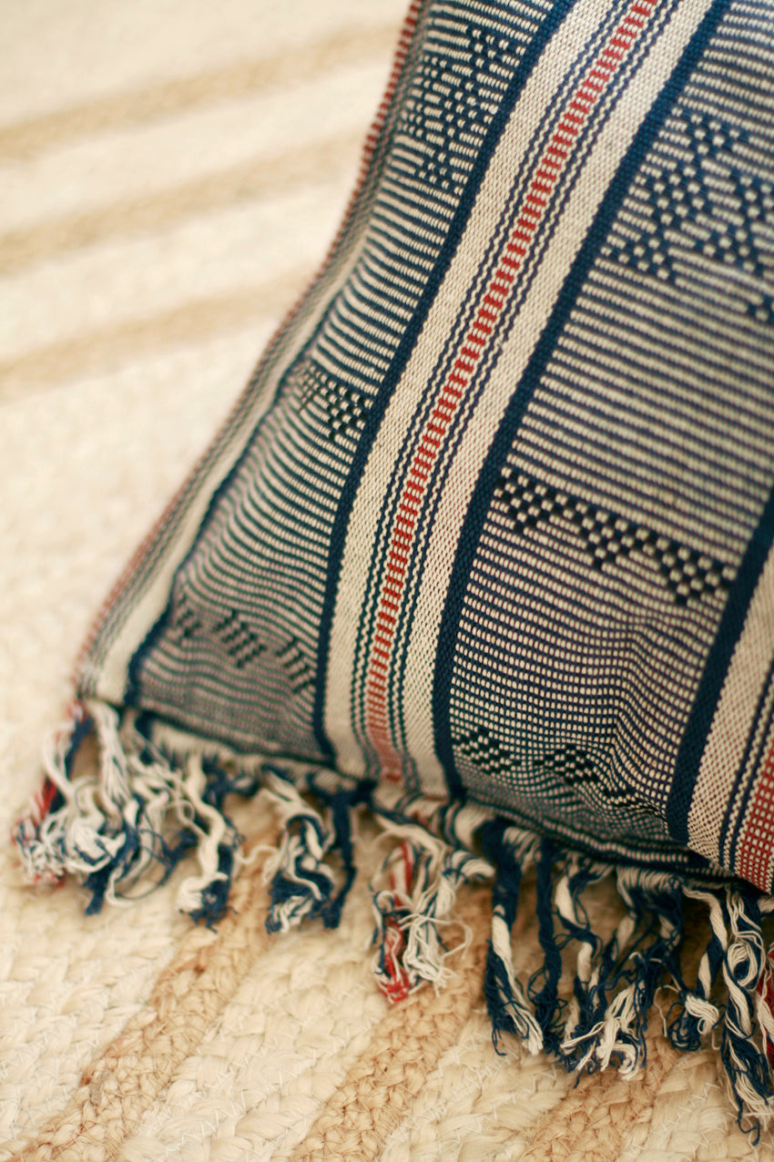 Handwoven Sumba ikat decorative pillow cover featuring vibrant traditional woven patterns.