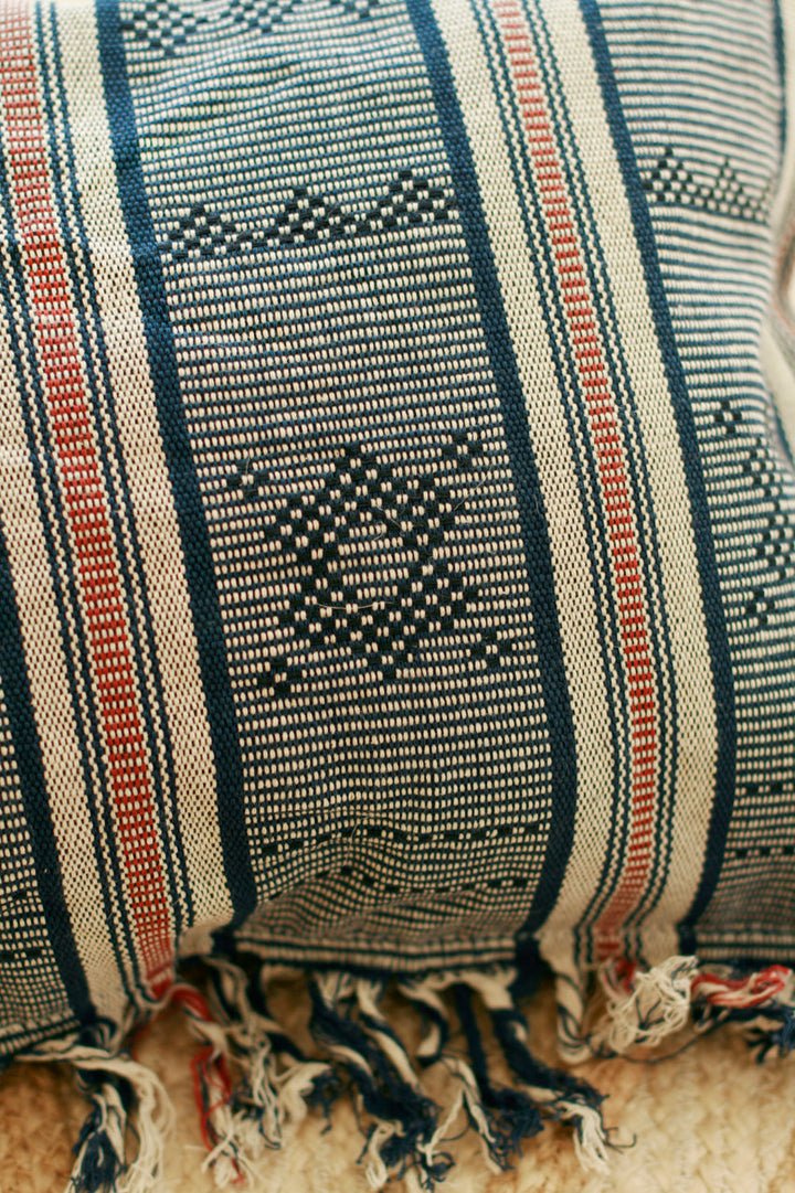 Handwoven Sumba ikat decorative pillow cover featuring vibrant traditional patterns and rich textile craftsmanship.