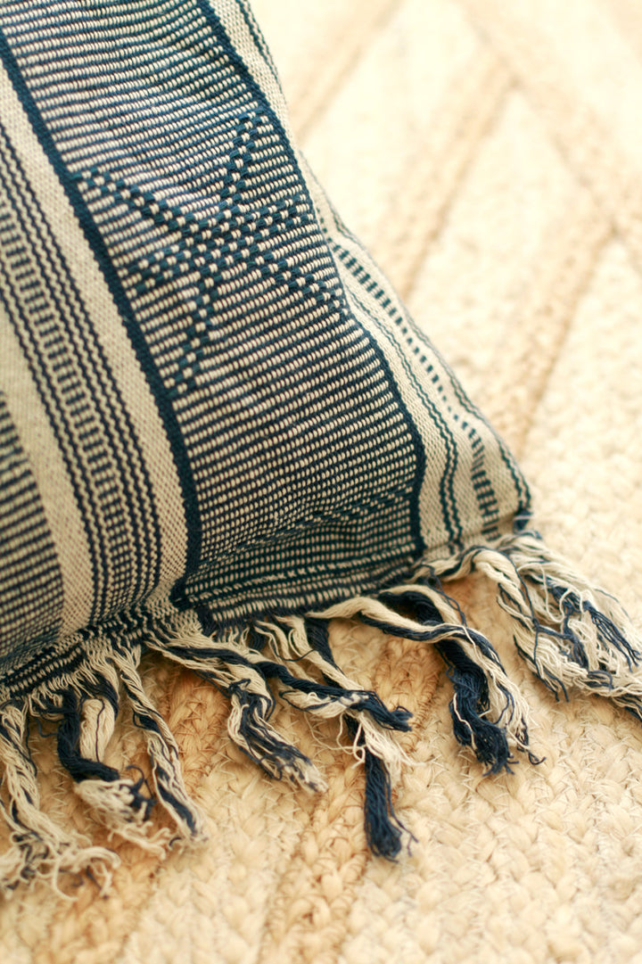 Blue striped ikat handwoven pillow featuring intricate Sumba weaving patterns.