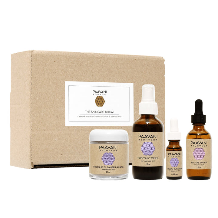 Tridoshic Ayurvedic skincare ritual set on a wooden surface.