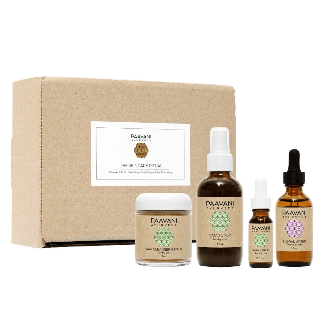 Vata Ayurvedic skincare ritual facial set with products and tools.