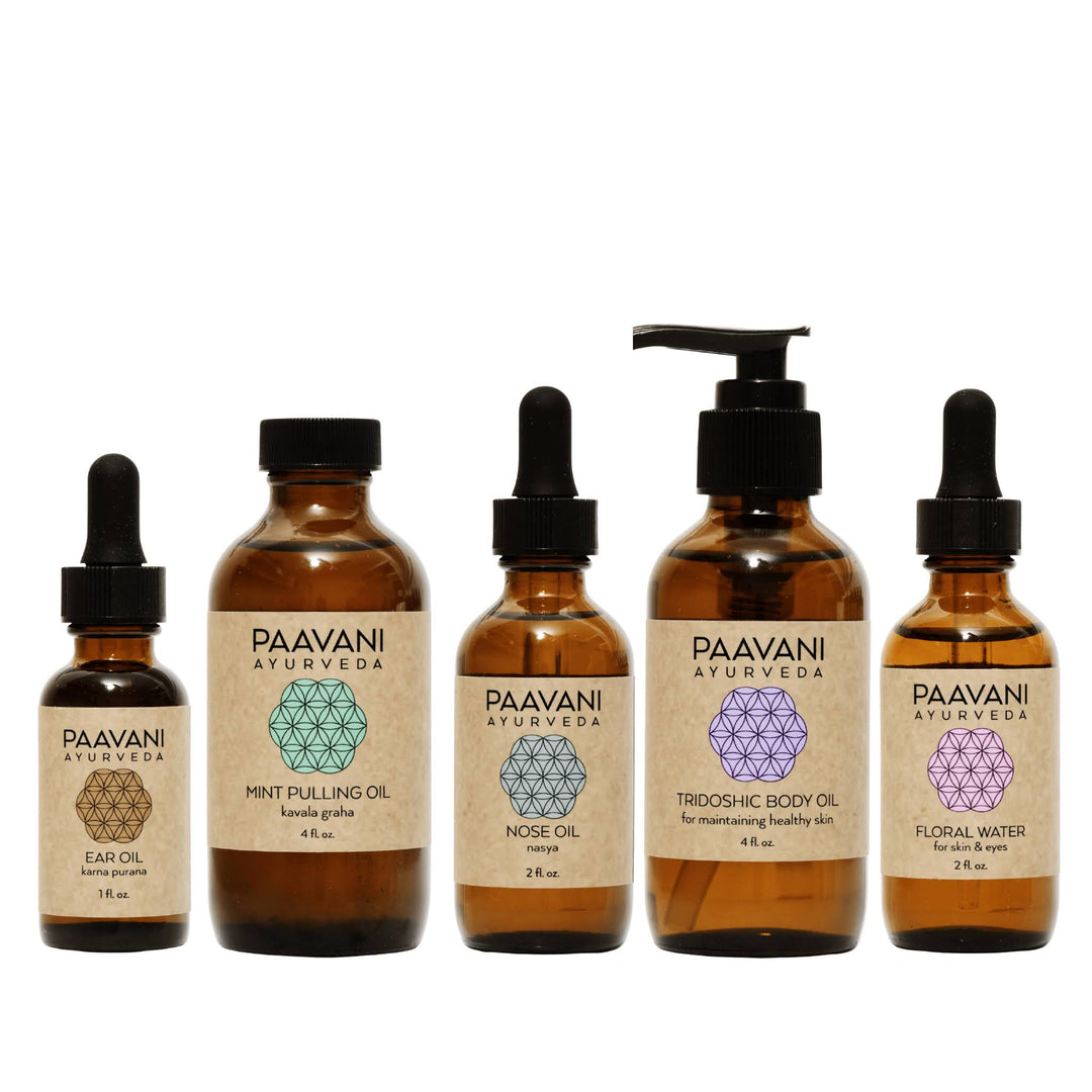 Dinacharya Ayurvedic self-care kit with oils and tools.