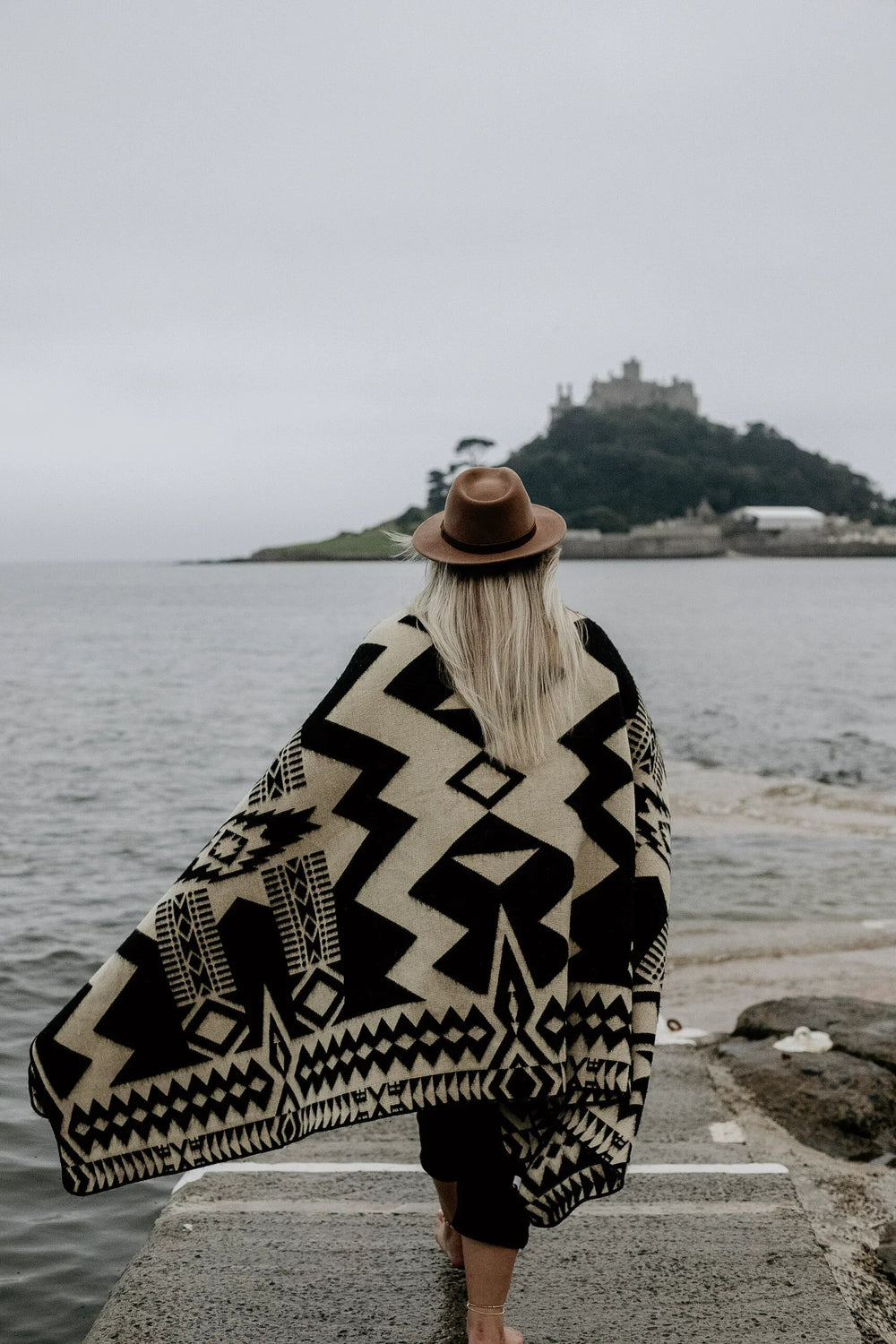 Black and natural cream Awa blanket showing the geometric weave and bound edge.
