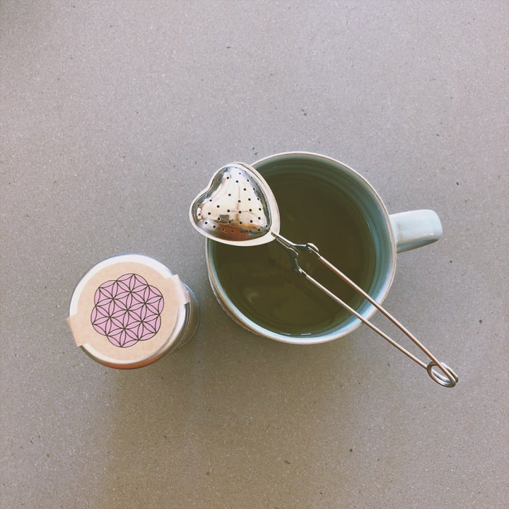 Heart-shaped stainless steel tea infuser for brewing loose-leaf tea.