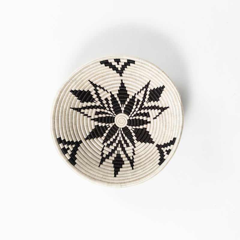 Overhead view of a medium Boutique Cactus Blossom woven bowl with a radiating bloom pattern.