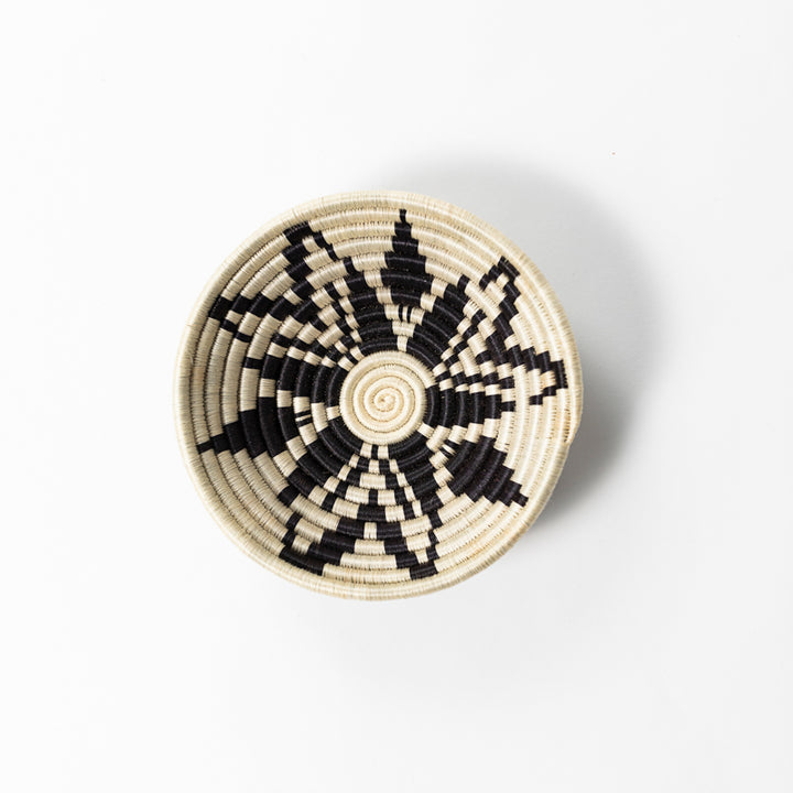 Overhead view of a small Boutique Cactus Blossom woven bowl in cream and black.