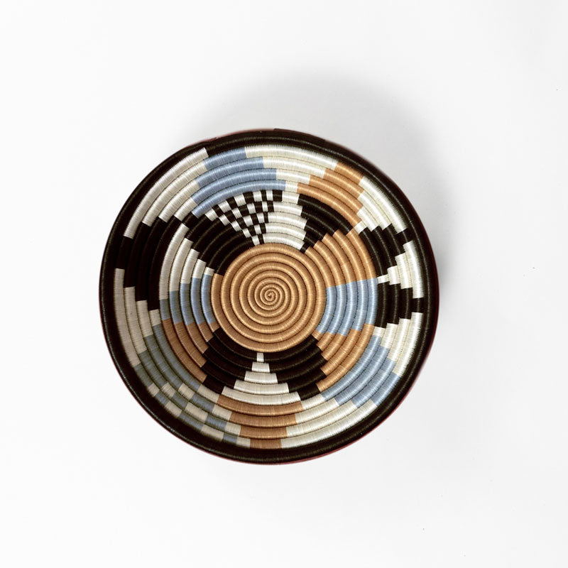 Overhead view of a medium Boutique Diversiform woven bowl in cool gray, camel, and cream.