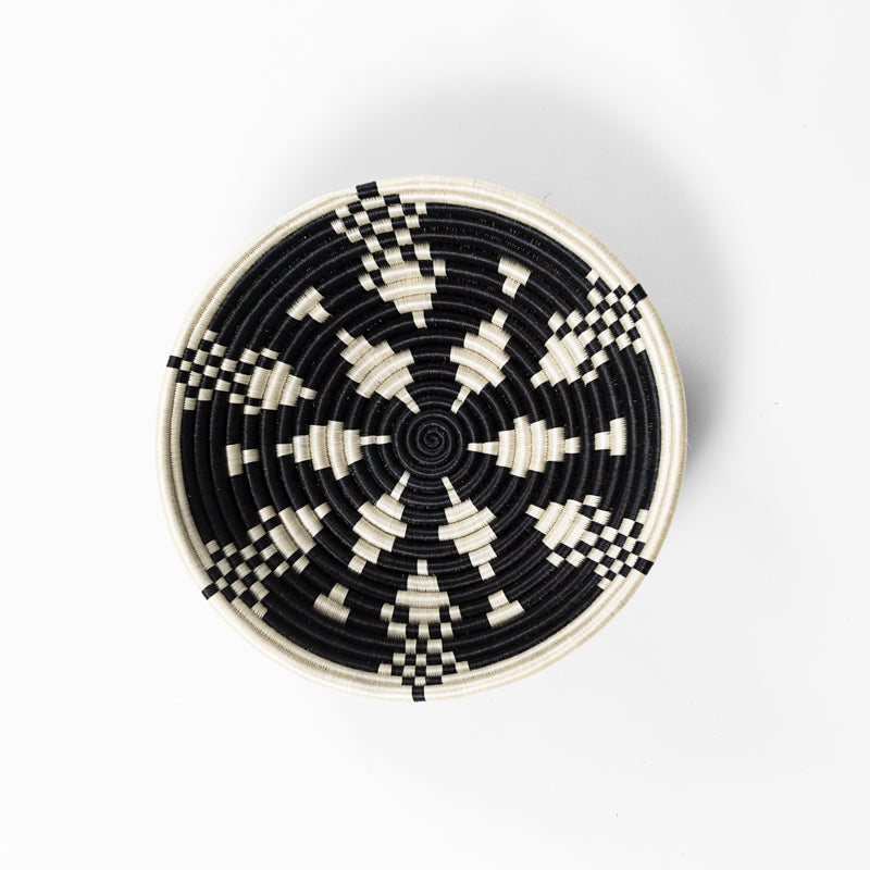 Overhead view of a medium Boutique Kaleidoscope woven bowl in black and cream.