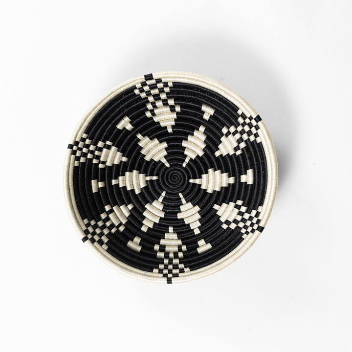 Overhead view of a medium Boutique Kaleidoscope woven bowl in black and cream.
