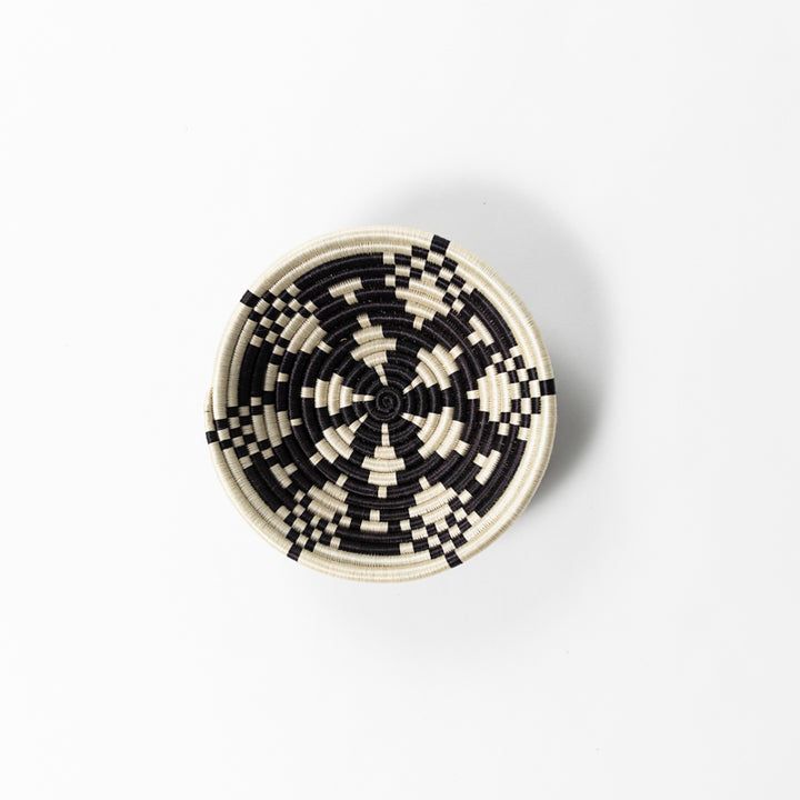 Overhead view of a small Boutique Kaleidoscope woven bowl in black and cream.