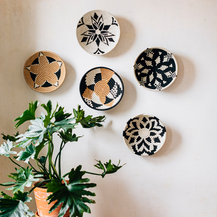 Boutique Vertex tea-dyed sisal woven bowls styled with plants on a neutral background.