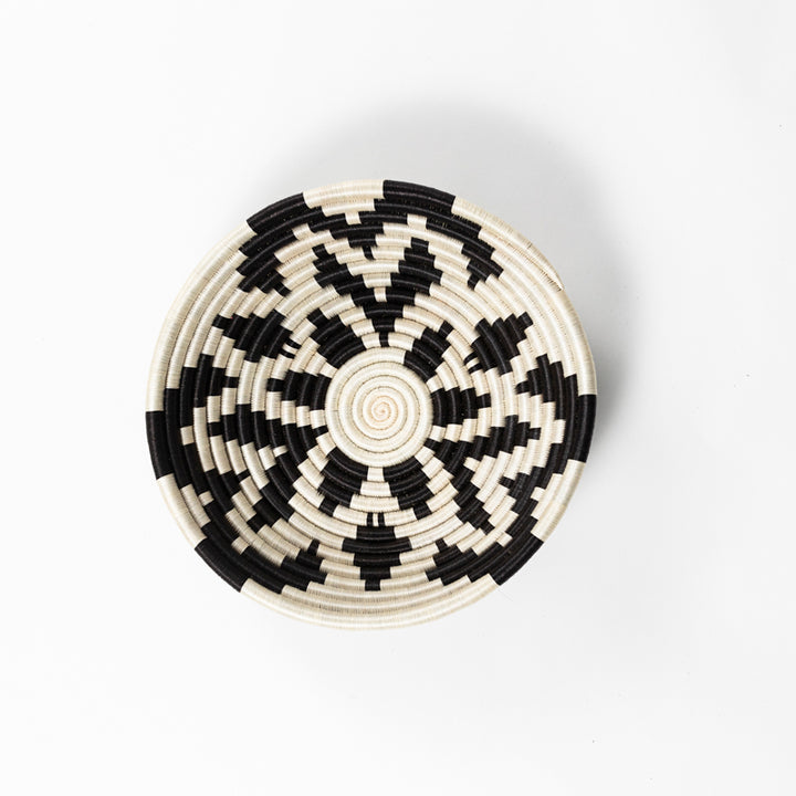 Overhead view of a medium Boutique Shamrock woven bowl in black and cream sisal.