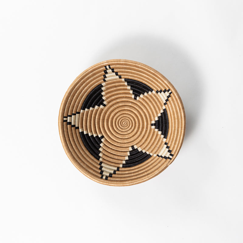 Overhead view of a medium Boutique Vertex woven bowl in tea-dyed sisal.