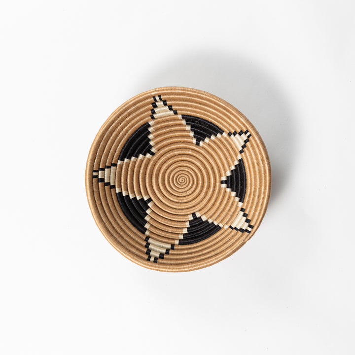 Overhead view of a medium Boutique Vertex woven bowl in tea-dyed sisal.