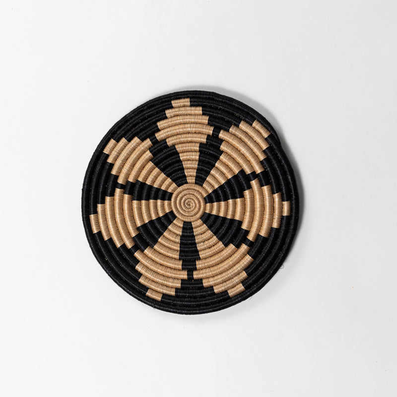 Round handwoven sisal trivets with natural texture and tea-dyed tones.