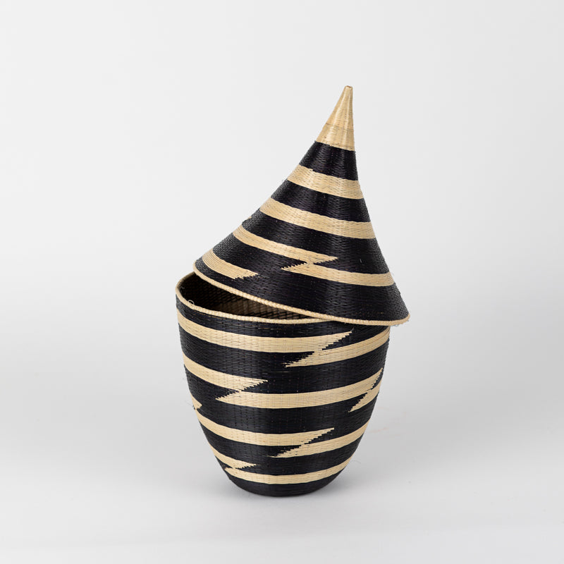 Handwoven black and white grass peace basket with a fitted lid.
