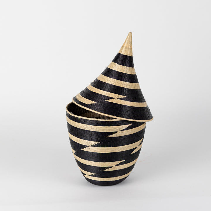Handwoven black and white grass peace basket with a fitted lid.