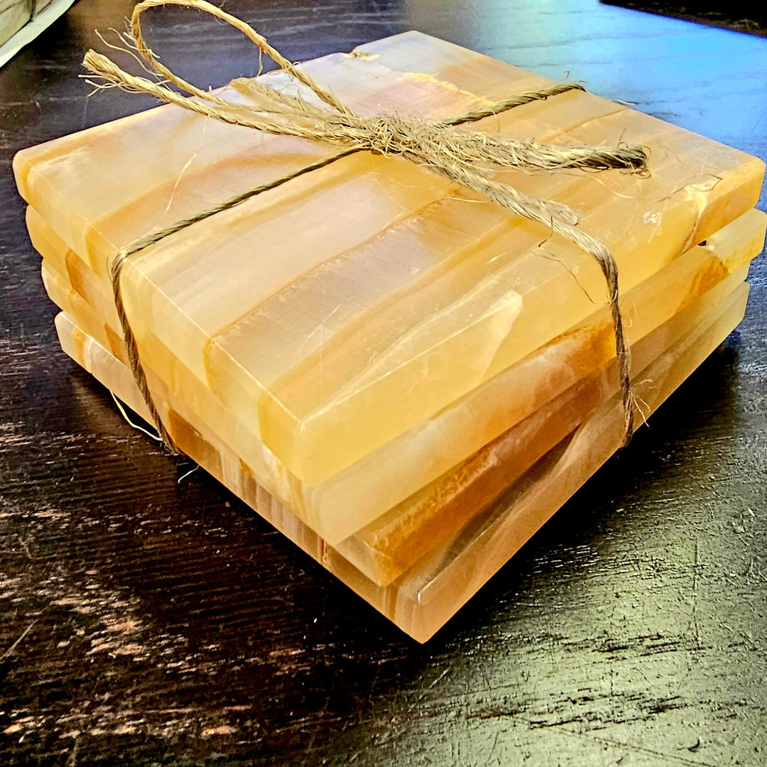 Onyx drink coasters with warm gold and dark veining, set of four.