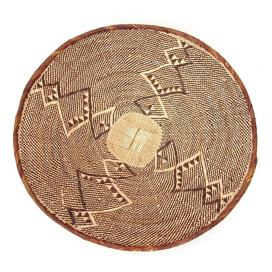 Five Tonga wall baskets with woven patterns and natural-fiber texture.