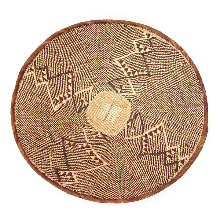Five Tonga wall baskets with woven patterns and natural-fiber texture.